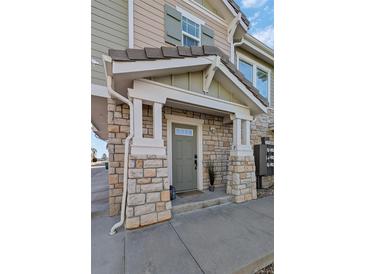 Charming stone-accented front entrance with a covered porch, offering curb appeal at 9771 Mayfair St # F, Englewood, CO 80112