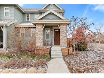 Charming two-story home featuring a stone-accented porch and inviting entryway at 2591 Iola St, Aurora, CO 80010