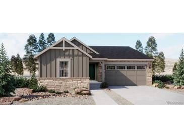Charming single-Gathering home featuring stone accents, a two-car garage, and a landscaped front yard at 21966 E 39Th Pl, Aurora, CO 80019