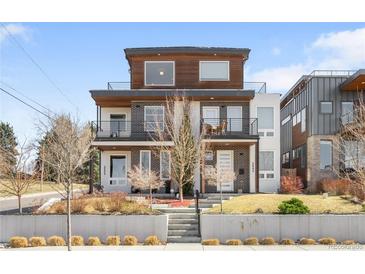 Modern two-story duplex featuring a brick facade, balconies, and manicured front yard at 2600 S Sherman St, Denver, CO 80210