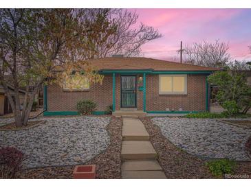 Charming brick home with a rock front yard and a welcoming, covered entryway at 8511 Essex Dr, Denver, CO 80229