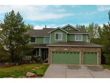 Inviting two-story home featuring a three-car garage and nicely landscaped front yard at 919 Taylor Ln, Erie, CO 80516