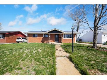 Charming red brick home with a well-maintained lawn and walkway leading to the front door at 3341 W 94Th Ave, Westminster, CO 80031