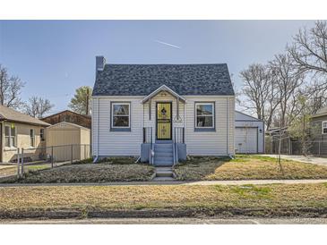 Exterior shot of a bright home with a well-manicured lawn and a detached garage providing ample parking at 4354 Chase St, Denver, CO 80212