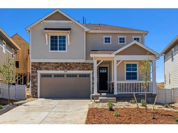 Charming two-story home featuring stone accents, a covered porch, and an attached two-car garage at 459 S Salida St, Aurora, CO 80017