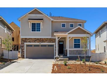 Charming two-story home with a stone facade, covered porch, and attached garage at 459 S Salida St, Aurora, CO 80017