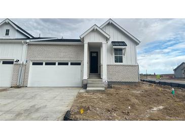 Charming single-Gathering home featuring brick accents, a two-car garage, and a welcoming front entrance at 3408 N Duquesne Way, Aurora, CO 80019