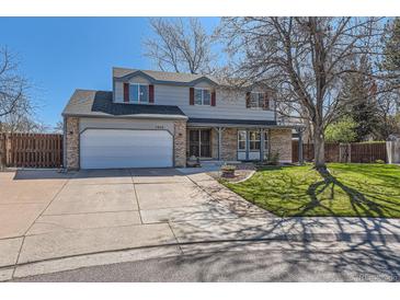 Charming two-story home with a well-maintained lawn and a two-car garage on a sunny day at 7926 S Corona Ct, Centennial, CO 80122
