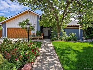 Charming home exterior featuring a well-maintained lawn, mature trees, and a welcoming walkway at 5884 S Hanover Way, Greenwood Village, CO 80111