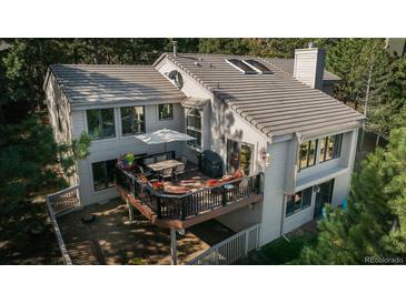 Back exterior view from above showcasing deck and trees at 947 Dogwood Dr, Golden, CO 80401