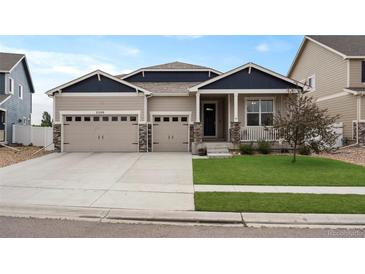 Charming home with a three-car garage, well-maintained lawn, and stone column accents at 2200 Cadman St, Berthoud, CO 80513