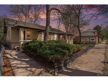 Charming bungalow-style home with manicured landscaping and inviting front porch at 3726 Decatur St, Denver, CO 80211