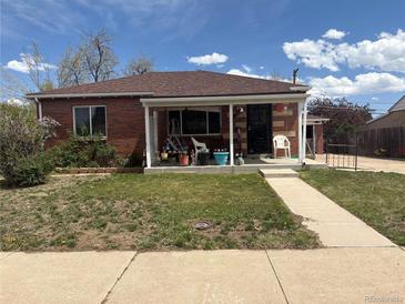 Charming brick home with a cozy front porch and well-maintained lawn, perfect for relaxing outdoors at 1516 S Lowell Blvd, Denver, CO 80219