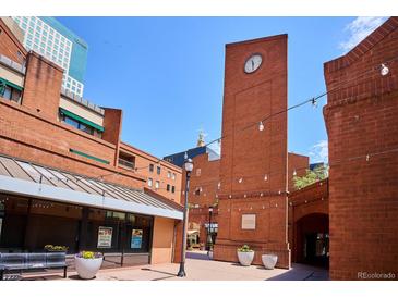 Writer Square's clock tower and brick buildings create a charming urban scene with shops and outdoor seating at 1512 Larimer St # 39, Denver, CO 80202