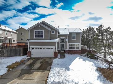 Charming two-story home with a two-car garage and snow-covered yard, offering curb appeal at 4053 S Riviera St, Aurora, CO 80018