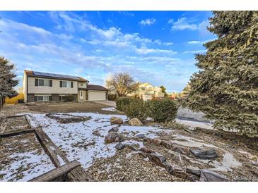 Ranch style home with a landscaped front yard and solar panels at 12263 Clermont Ct, Thornton, CO 80241