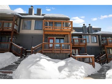 Exterior view of a modern condo with snowy landscape and wooden balconies at 147 Illinois Gulch Rd # 4, Breckenridge, CO 80424