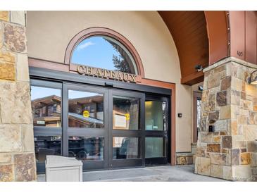 Welcoming stone entrance to the Chateaux building with automatic doors, great location and amenities at 405 Village Rd # 405, Breckenridge, CO 80424