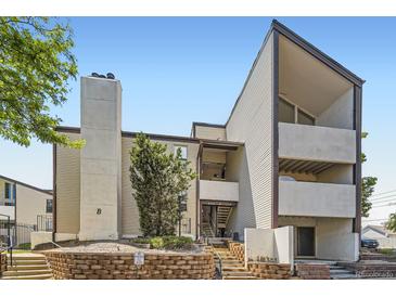 Contemporary apartment building featuring a concrete chimney and stairways to upper-level units at 3539 S Fairplay Way # 10, Aurora, CO 80014