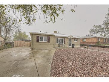 Cozy one-story home featuring a charming brick exterior and landscaped front yard at 9391 Lilly Ct, Thornton, CO 80229