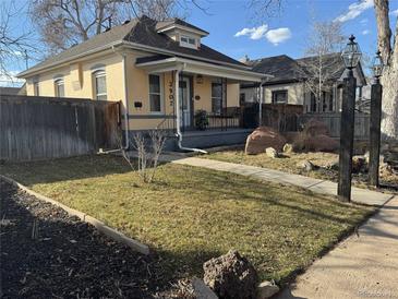 Charming home featuring a well-kept lawn, lovely landscaping, and inviting front porch, perfect for relaxing and enjoying the outdoors at 3907 S Lincoln St, Englewood, CO 80113