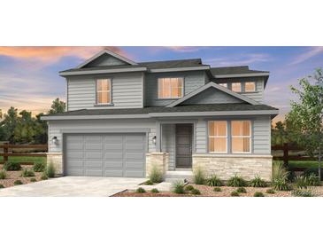 Two-story home with gray siding, stone accents, and a two-car garage at 4304 Ridgewalk Pt, Castle Rock, CO 80108