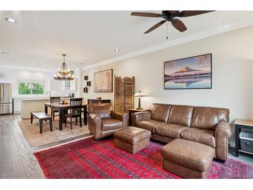 Bright, open-concept living space with hardwood floors and neutral walls for versatile decor at 48 Galapago St, Denver, CO 80223