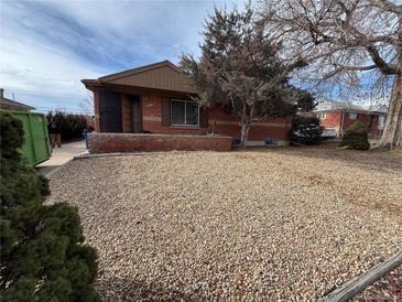Charming single-story home featuring a rock yard and mature trees in a quiet neighborhood at 7795 Raritan St, Denver, CO 80221