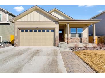 Charming home featuring a two-car garage, stone accents, and a welcoming front porch at 120 Sabin Way, Lochbuie, CO 80603