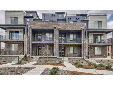 Modern townhomes featuring brick and siding exteriors, private balconies, and landscaped front yards at 9645 Browns Peak Cir, Littleton, CO 80125
