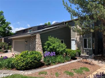 Charming home featuring stone accents, a two-car garage and lush landscaping at 1503 W Briarwood Ave, Littleton, CO 80120