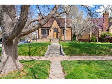 Charming brick home with well-maintained front yard and inviting entryway, creating a warm curb appeal at 2088 Kearney St, Denver, CO 80207