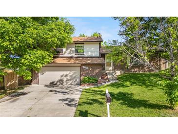 Charming two-story home with brick facade, attached garage, and well-maintained lawn in a desirable neighborhood at 19398 E Eastman Pl, Aurora, CO 80013
