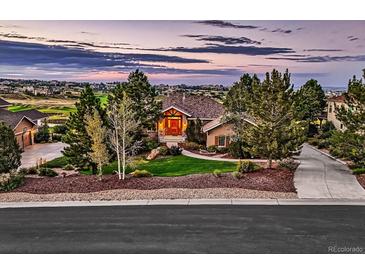 Beautiful home with lush landscaping, mature trees, a red front door, and a view of the golf course and neighborhood at 5149 Raintree Dr, Parker, CO 80134
