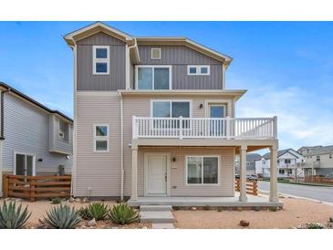 Charming two-story home featuring a balcony, landscaped front yard, and modern design elements at 46570 Avery Ln, Bennett, CO 80102