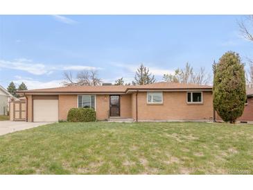 Charming single-story brick home features a well-maintained lawn, an attached garage, and an inviting entryway at 117 S Pierce St, Lakewood, CO 80226