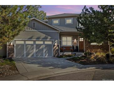 Charming two-story home featuring a gray exterior, attached garage, and well-manicured landscaping at 4193 W 99Th Ct, Westminster, CO 80031