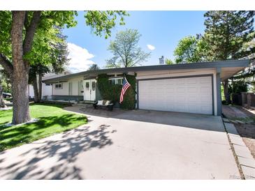 Charming single-story home with a well-manicured lawn and a two car garage at 4545 S Lipan Ct, Englewood, CO 80110