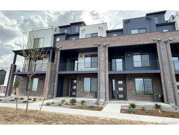 Modern townhome with brick facade, balconies, and contemporary design at 8321 Mount Kataka St, Littleton, CO 80125
