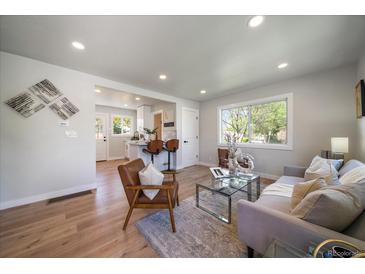 Bright, open-concept living room with modern decor, wood floors, and plenty of natural light at 3200 N Elizabeth St, Denver, CO 80205