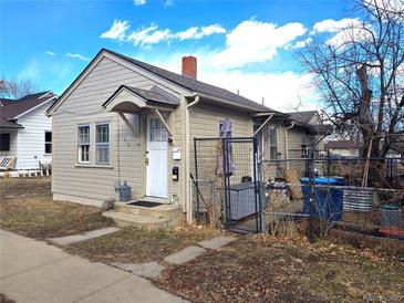 Charming exterior showcasing a quaint home with a small covered entryway and partially fenced yard at 914 La Farge Ave, Louisville, CO 80027