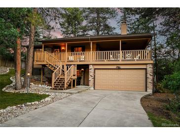Inviting two-story home featuring a charming covered porch and a convenient two-car garage at 9416 Mcshane Ct, Parker, CO 80134