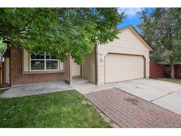 Charming single-Gathering home featuring a two-car garage and a well-manicured lawn at 8401 Sandreed Cir, Parker, CO 80134