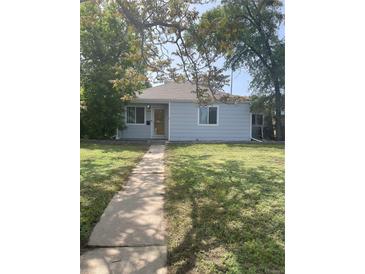 Charming single-story home featuring a well-maintained lawn and inviting walkway to front door at 11502 E 7Th E Ave, Aurora, CO 80010