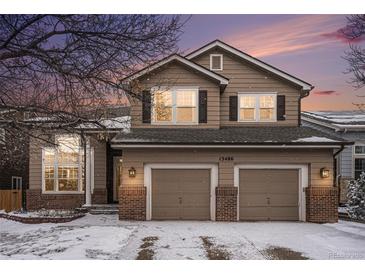 Charming two-story home featuring a two-car garage, brick accents and beautiful landscaping at 13486 Clayton St, Thornton, CO 80241
