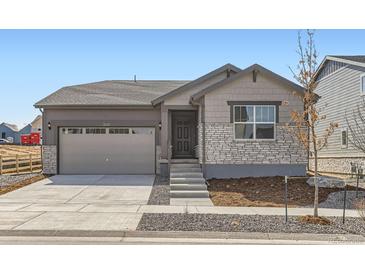 Charming single-Gathering home featuring stone accents, a two-car garage, and a well-maintained front yard at 22036 E 39Th Pl, Aurora, CO 80019