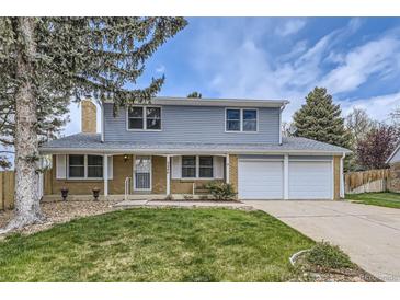 Charming two-story home with a well-maintained lawn and a two car garage at 3240 E 128Th Pl, Thornton, CO 80241
