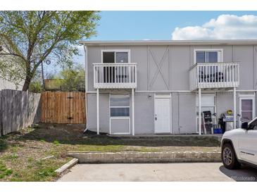 Two-story townhouse featuring private balconies and a gray painted exterior at 4670 W Nevada Pl # A, Denver, CO 80219