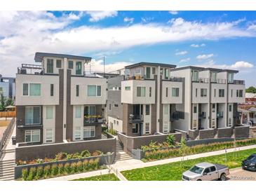 Modern townhomes with balconies, roof decks, brick accents, and manicured landscaping offer luxury living at 1583 Grove St # 5, Denver, CO 80204
