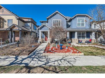 Charming blue home with landscaped front yard at 1145 S Logan St, Denver, CO 80210